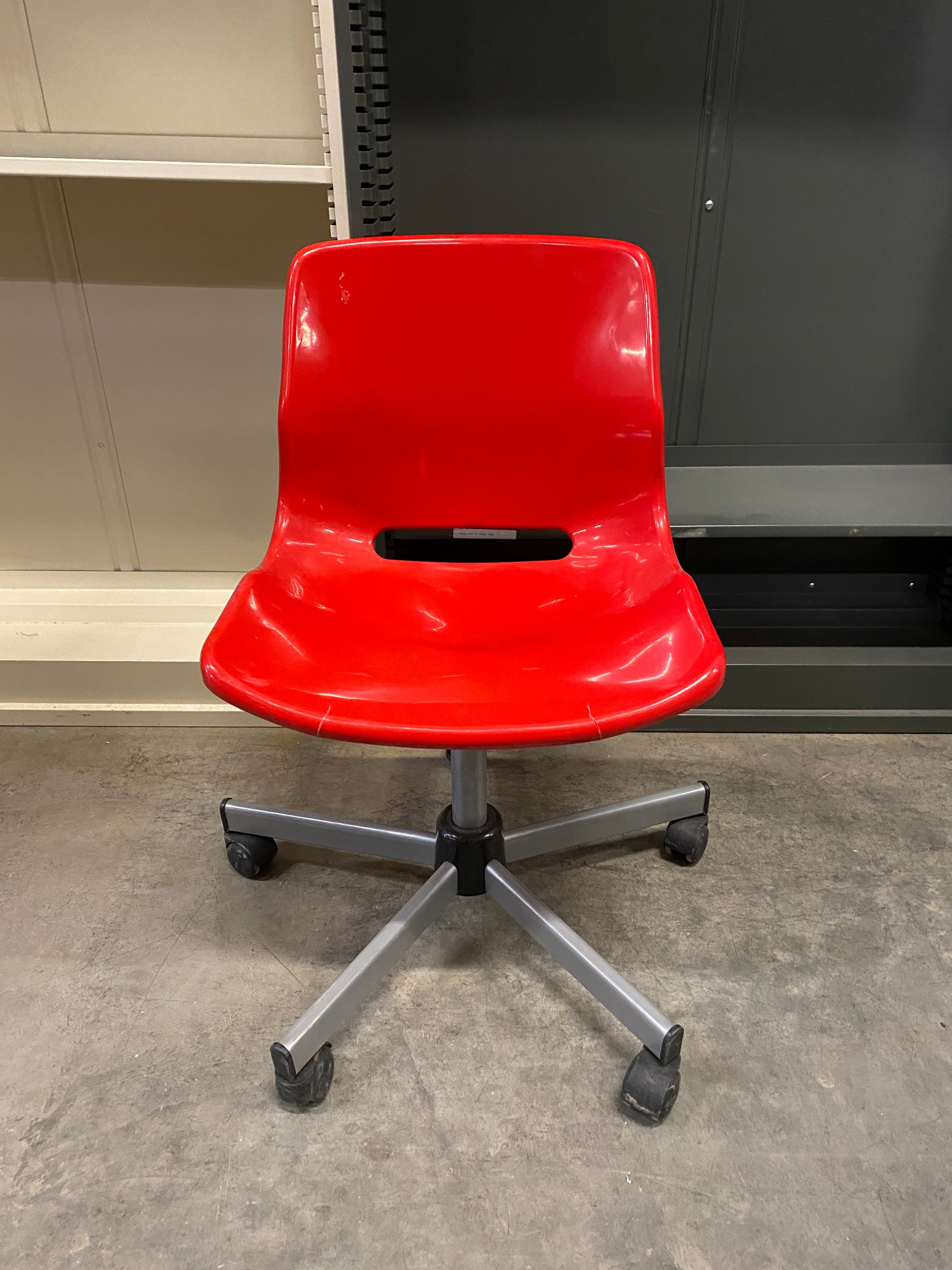 Red Plastic Chair on Wheels