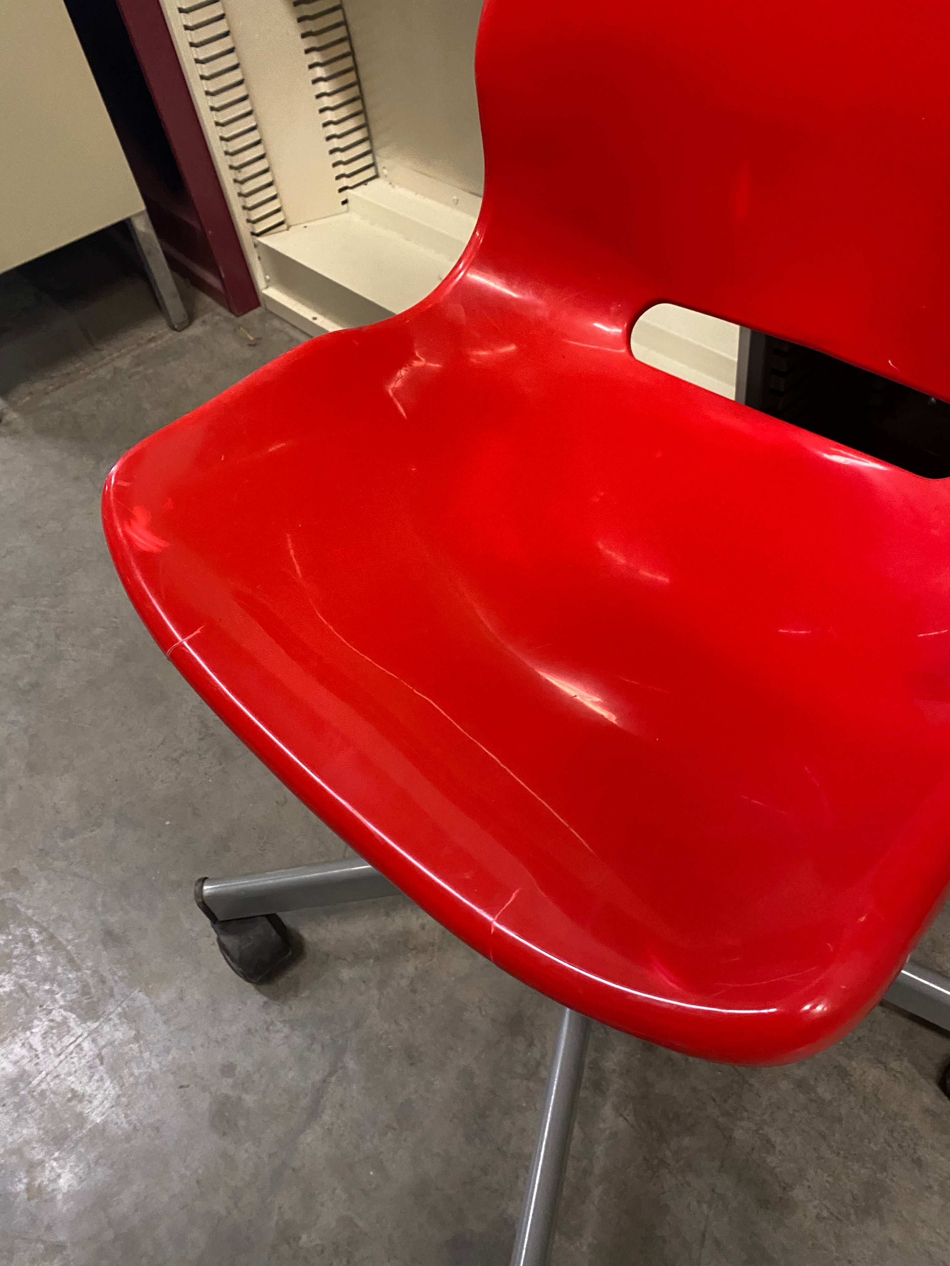 Red Plastic Chair on Wheels