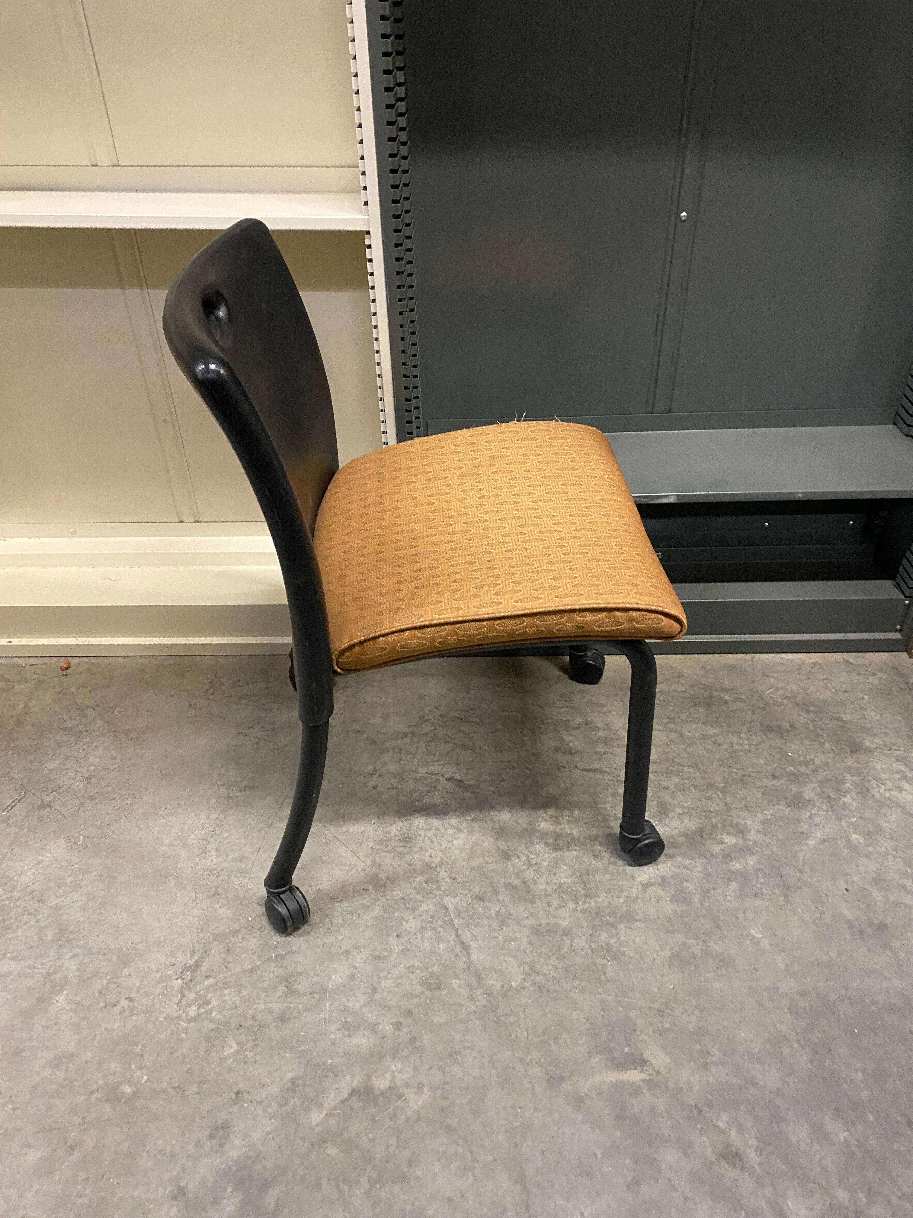 Black Plastic Chair with an Upholstered Cushioning