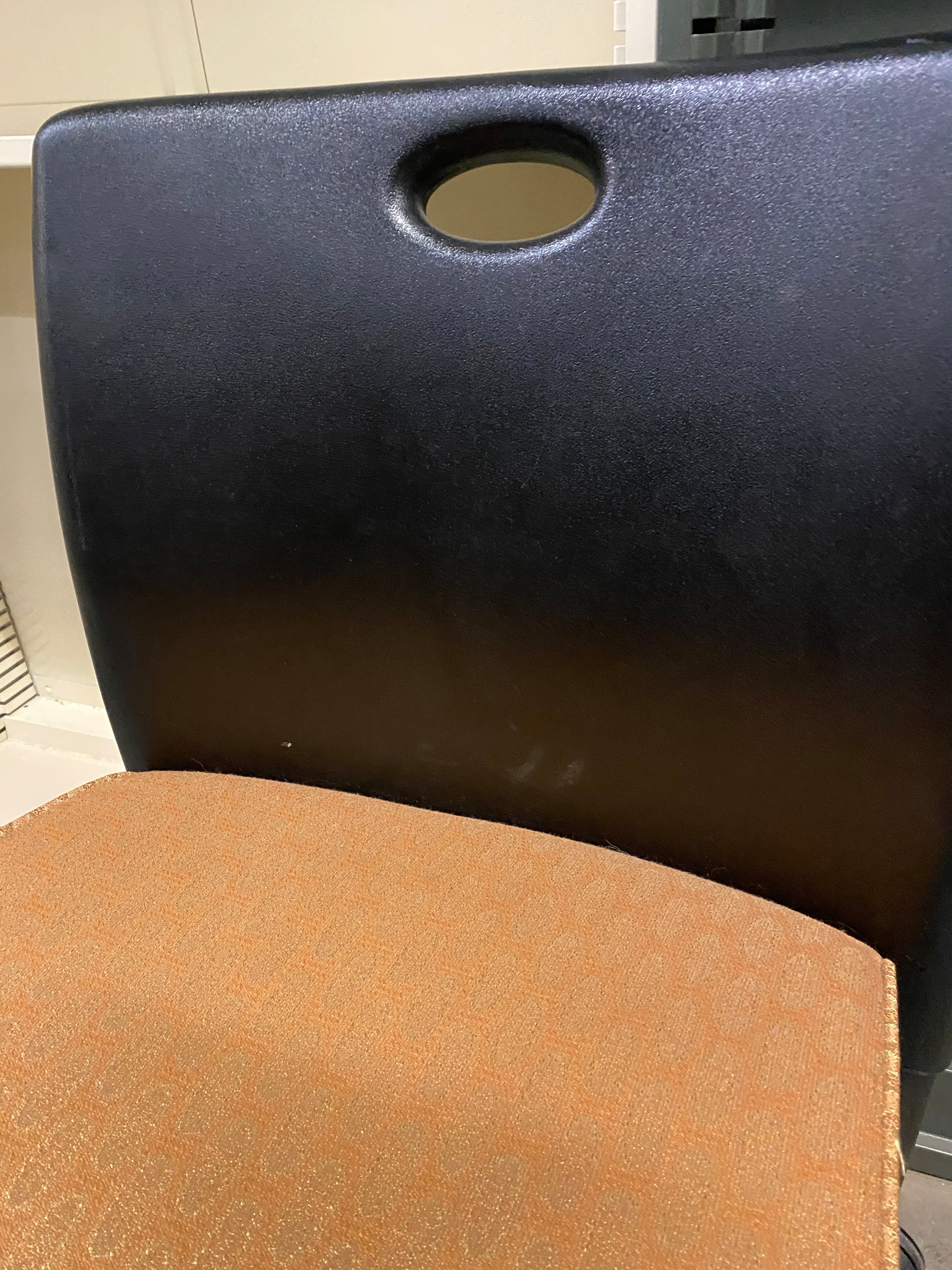 Black Plastic Chair with an Upholstered Cushioning