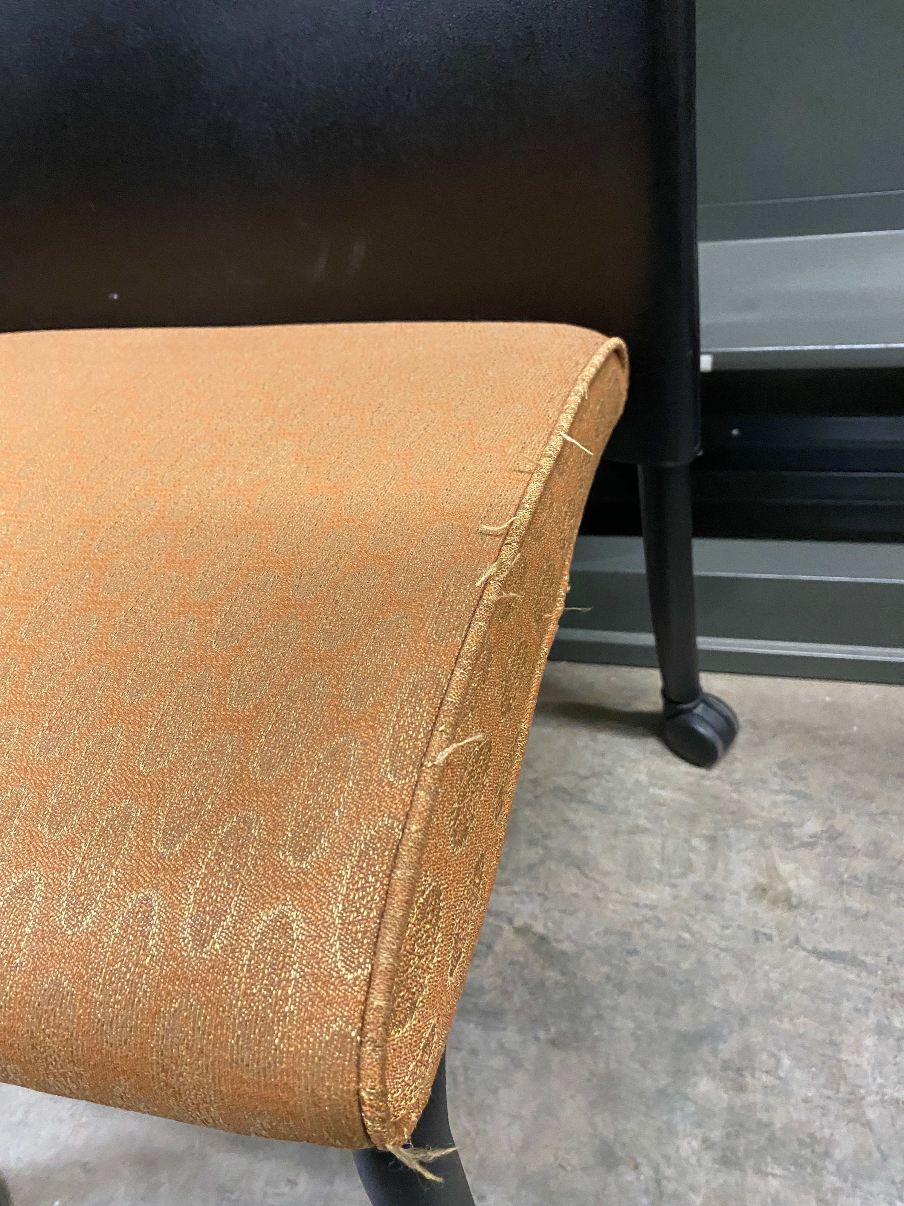 Black Plastic Chair with an Upholstered Cushioning