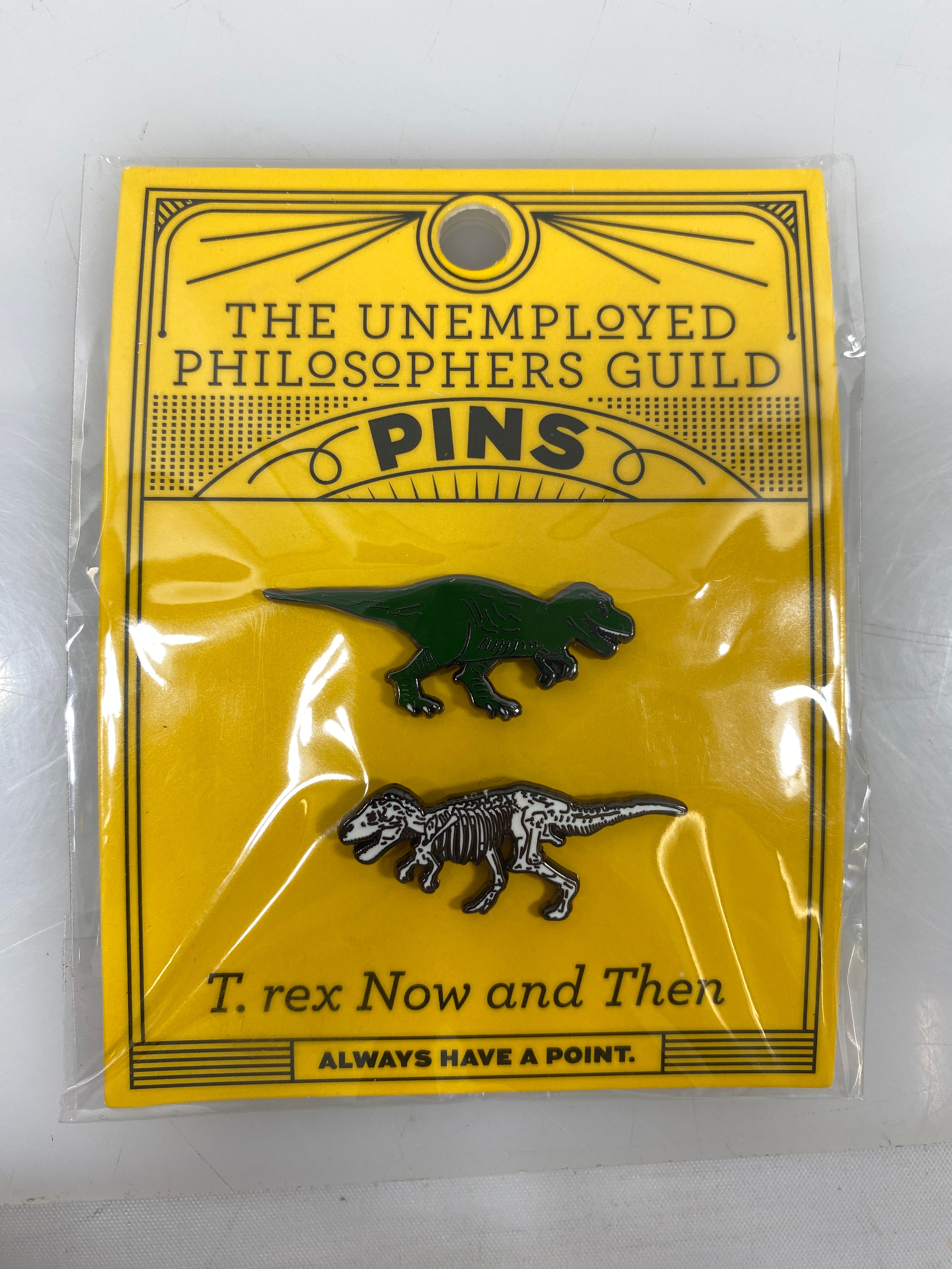 The Unemployed Philosophers Guild T. rex Now and Then Pins
